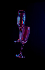 two glasses of champagne with neon purple lights. modern futurism 2022 year background. minimalism. surrealism. creative decoration idea