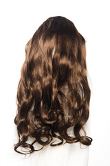 Brown brunette long curl hair wig on mannequin head over white background isolated