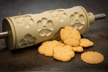 Floral butter cookies with flower mold. Photographed on an old metal baking sheet.