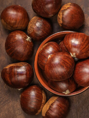 Chestnuts on on an old board with copy space. Autumn mood.  Horse chestnuts top view