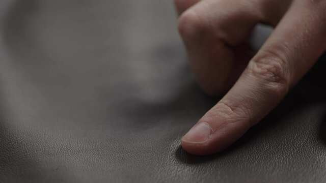 Slide shot man touching fine leather closeup