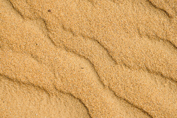 Sandy texture on the beach, black sea coast. Top view of abstract beach sand dunes for summer banner background.