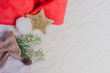 Santa Claus hat, Christmas tree branch and decorations over white background and copy space.Merry Christmas card