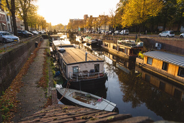 Sunny, autumn afternoon at the canal in the city of Groningen. - obrazy, fototapety, plakaty