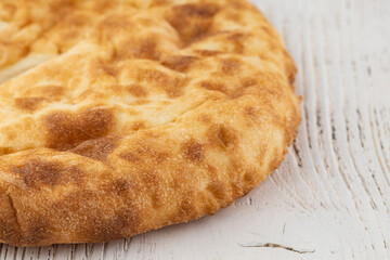 Traditional Croatian rustic bread - close up of a flatbread pita with salt, garlic and olive oil