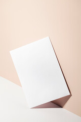 paper card note on beige background with shadow.