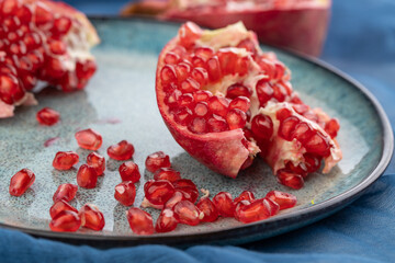 ripe pomegranate on a table on a blue background