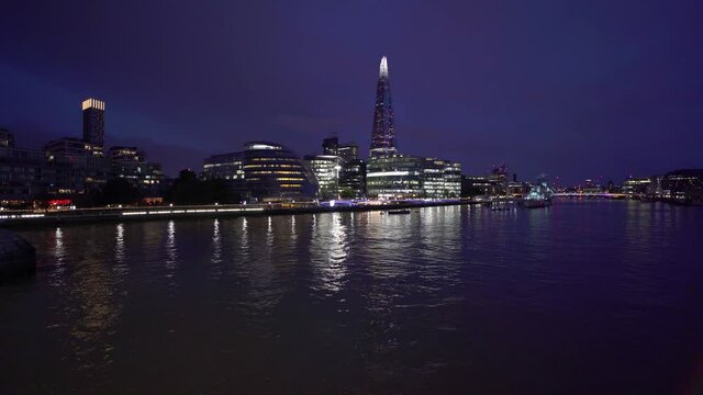 London skyline at night. View of the southbank of the river Thames showing the city, the Shard skyscraper and HMS Belfast. England