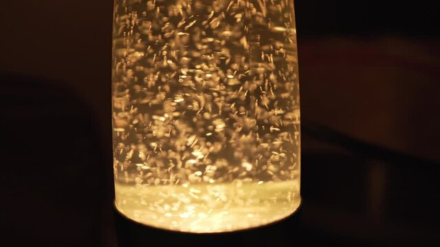 Old Green Lava Lamp with Particle Movement Inside. Romantic Evening Mood Created With Lighting Fixtures