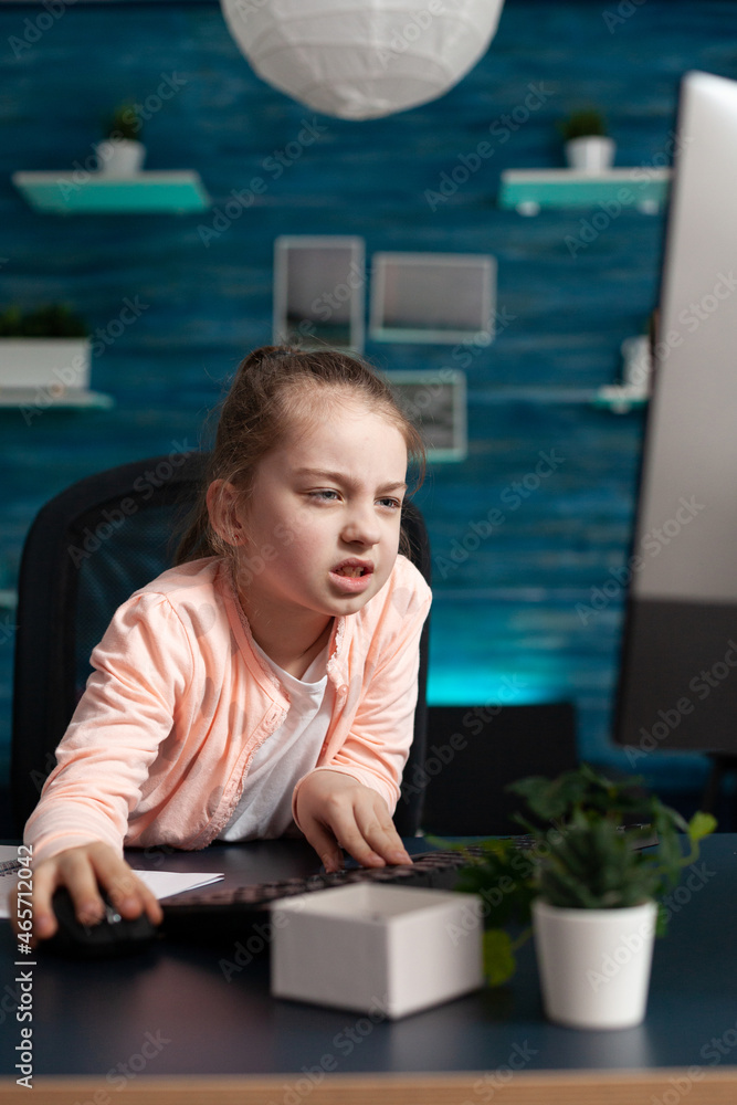 Poster tired exhausted child browsing school course information on computer while working at literature hom