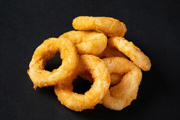 onion rings on the black background