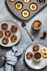 Mini donuts covered with chocolate glaze.