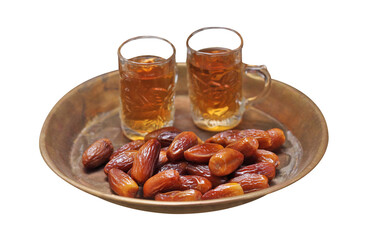 dates fruit and tea in golden tray on white background