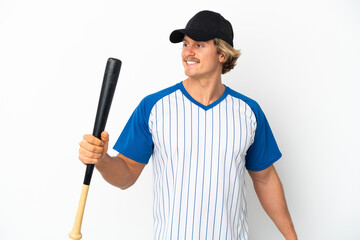 Young blonde man isolated on white background playing baseball