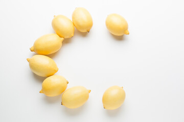 Several yellow bright lemons on a white background. Bright citruses.