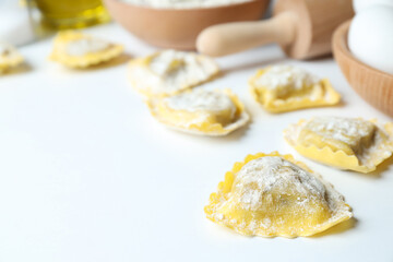 Concept of cooking ravioli on white background