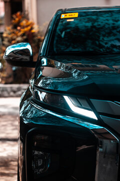 Vertical Shot Of A Black Car In A Stree