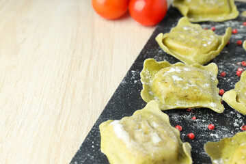 Concept of cooking ravioli on wooden background