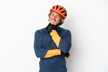 Young blonde cyclist man isolated on white background looking to the side and smiling