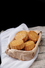 Chinese traditional mid-autumn festival cuisine: mooncakes in backet decorated with paper