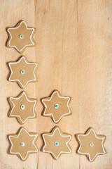 Star gingerbread cookies with frosting on wood board