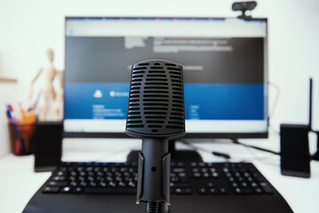 Microphone and computer monitore on the table. Online education concept