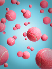 Flying pink tennis balls against pastel blue background. Creative sports concept. Minimal athletic,...