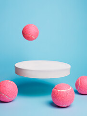 Creative sport layout made of podium and pink tennis balls on pastel pink background. Minimal 80's...