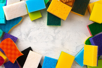 Pile of colorful cleaning sponges on gray background