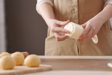 Fototapeta na wymiar Close-up image of woman preparing plastic form for making mooncakes for mid autumn season