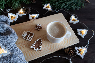 Coffee cup, glazed painted cookies, garland and warm blanket. Winter Holiday pattern