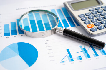 Obraz premium Magnifying glass and calculator on charts graphs paper. Financial development, Banking Account, Statistics, Investment Analytic research data economy, Stock exchange trading, Business office concept.