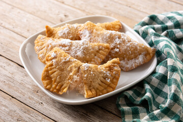 Spanish sweet stuffed pastry filled with angel hair on wooden table