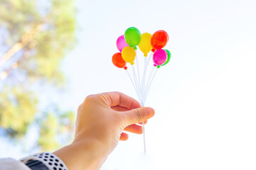 Bunch of toy balloons in hand