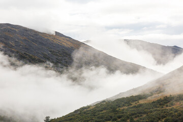 High mountain in mist and cloud.
