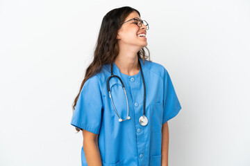 Young surgeon doctor caucasian woman isolated on white background laughing in lateral position