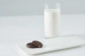 Biscuits filled with chocolate cream. Chocolate cream cookies or Choco fills served with cup of milk