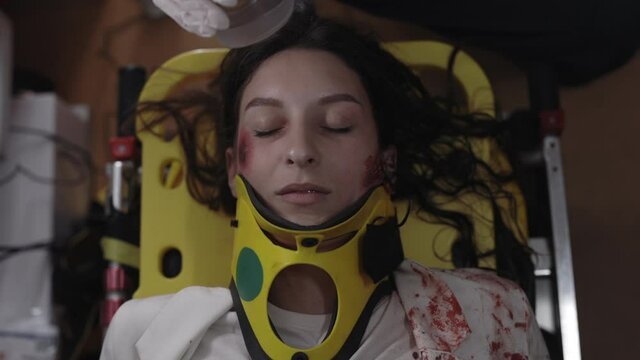 Paramedics using oxygen mask for female patient in ambulance