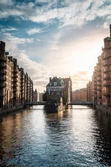 Famous historic warehouse district Speicherstadt under the cloudy sky in Hamburg, Germany © Florian Sngr/Wirestock