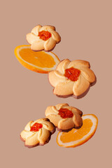 cookies with orange jam and orange slices beige background flying food