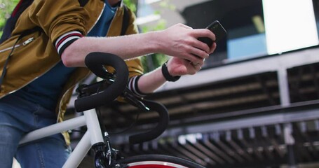 Happy albino african american man with dreadlocks on bike using smartphone - Powered by Adobe