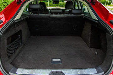 Fototapeta na wymiar Huge, clean and empty car trunk in interior of compact suv. Rear view of a SUV car with open trunk
