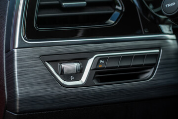Obraz na płótnie Canvas Headlights corrector adjustment buttons. Close up view of the modern car interior.