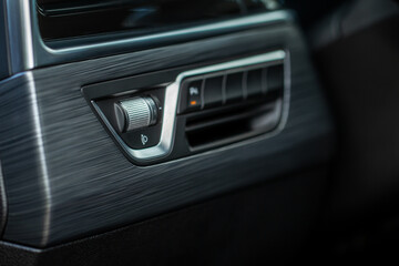 Obraz na płótnie Canvas Headlights corrector adjustment buttons. Close up view of the modern car interior.