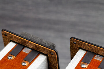 Flat foil ribbon tweeters presented against a gray background. Photo taken under artificial light