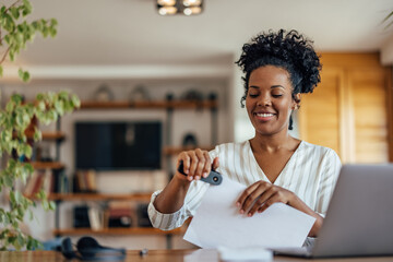Cheerful woman, making sure her desk is clean