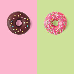 two delicious sweet donuts lie on a green background