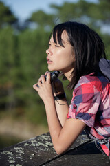 a woman using binoculars outdoors