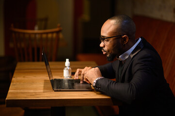 An African-American business man in a business suit is talking on a video conference. Video conference with partners