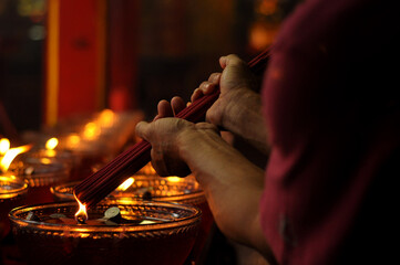 Residents of Chinese descent burning incense during worship at Vihara Glodok, Jakarta - Indonesia